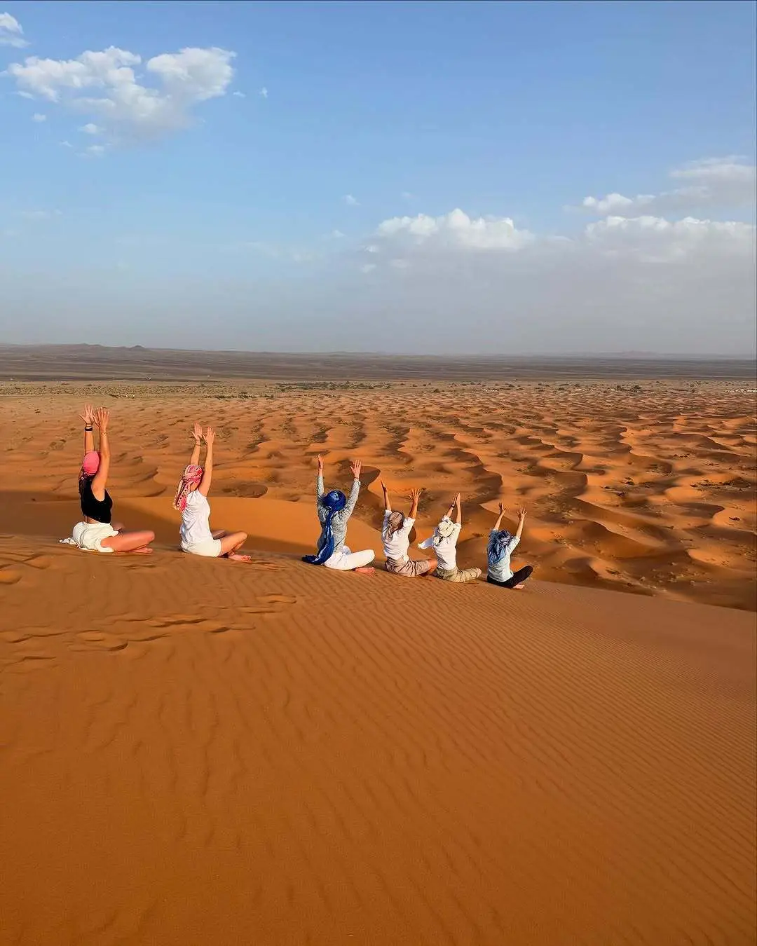 Yoga session desert bivouac Sahara Morocco